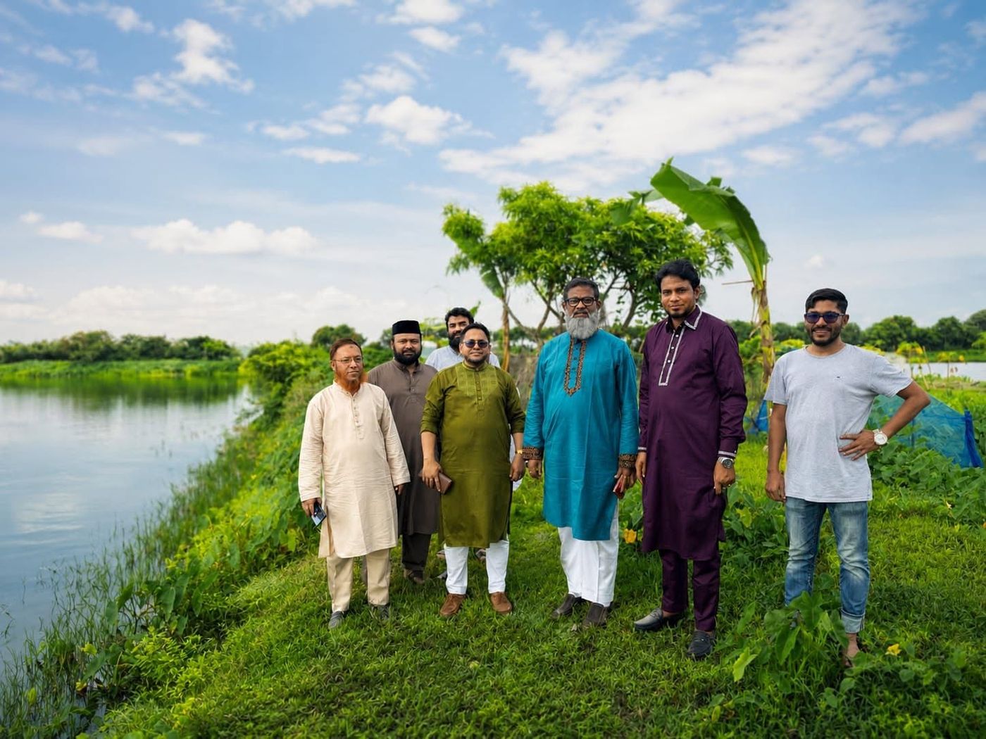 নীল আকাশের নিচে পুকুর পাড়ে প্রবাসী এগ্রো রিসোর্টের টিম